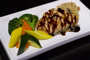 Chicken Breast topped with Monari Federzoni balsamic glaze and served with a side of steamed vegetables and quinoa pilaf (580 calories). 
