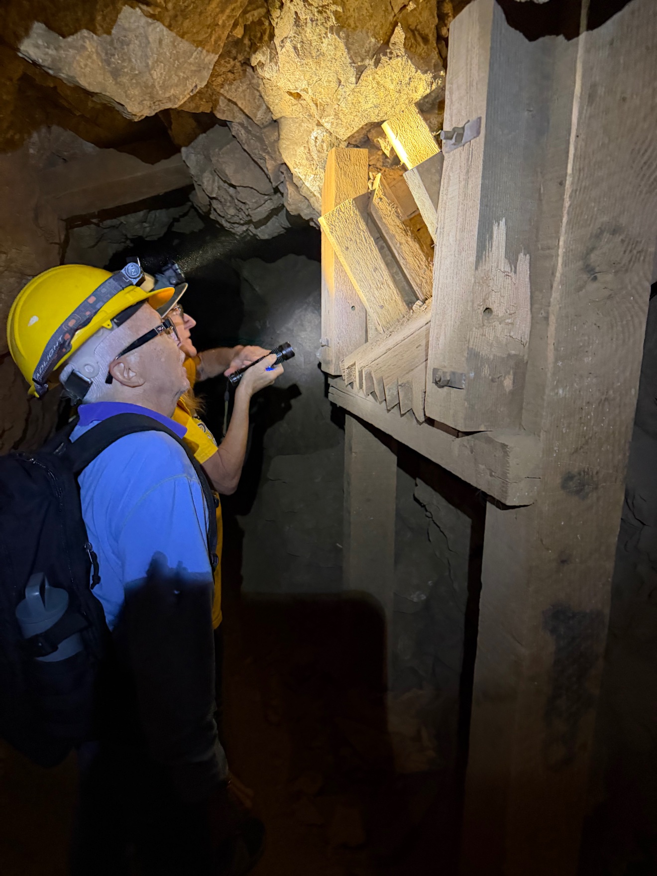 Scott examines the old timber ore chute by flashlight